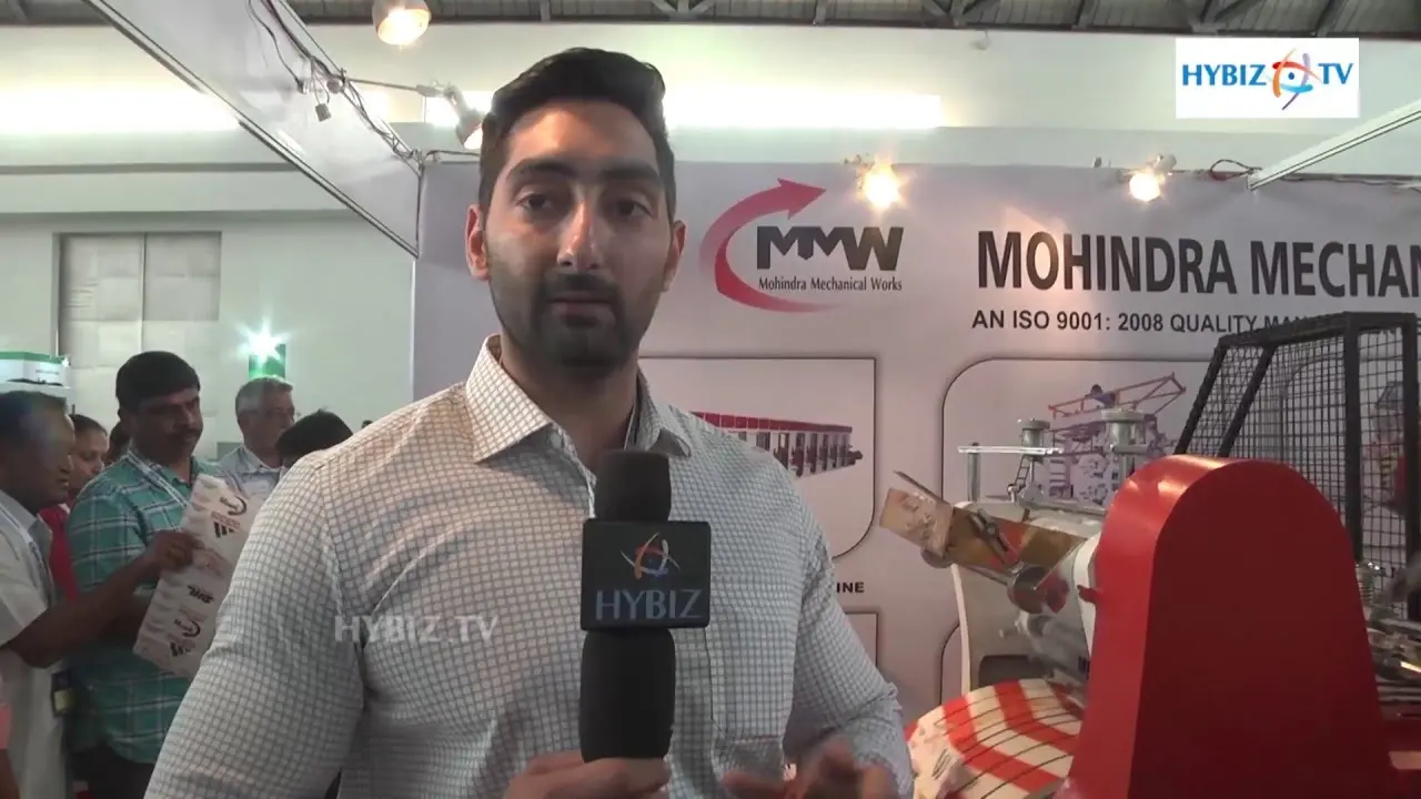 MMW owner giving interview at pharma tech expo for paper bag machine manufacturing